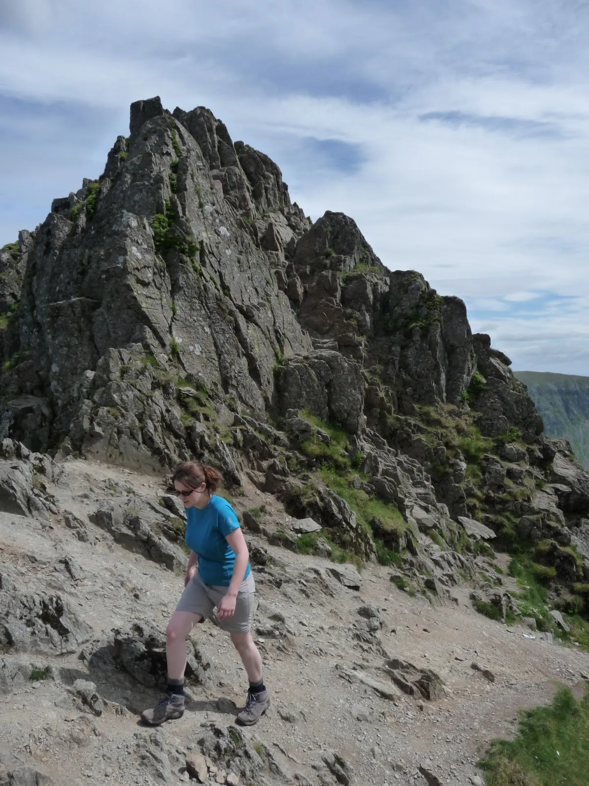 Woman walking across Crib Goch ridge walk