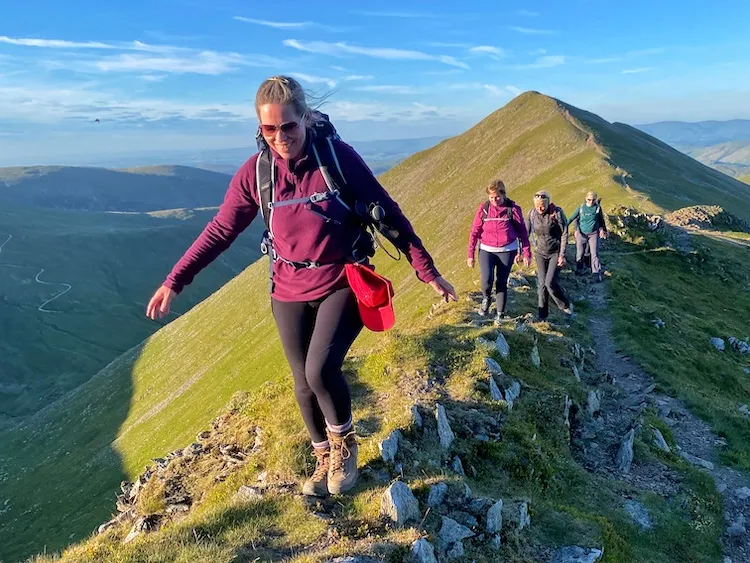 Woman walking upon Helvellyn during sunset